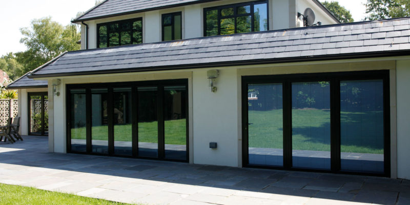 "Family enjoying energy-efficient aluminium windows by Flashglass Industry"