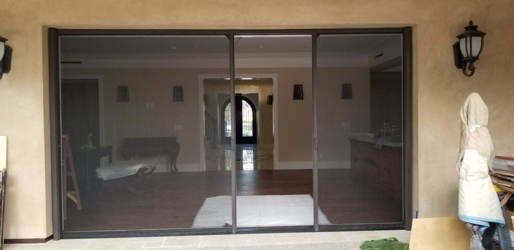 Durable Aluminium Sliding Doors for Kenyan Families" "Family enjoying aluminium sliding doors by Flashglass Industry"